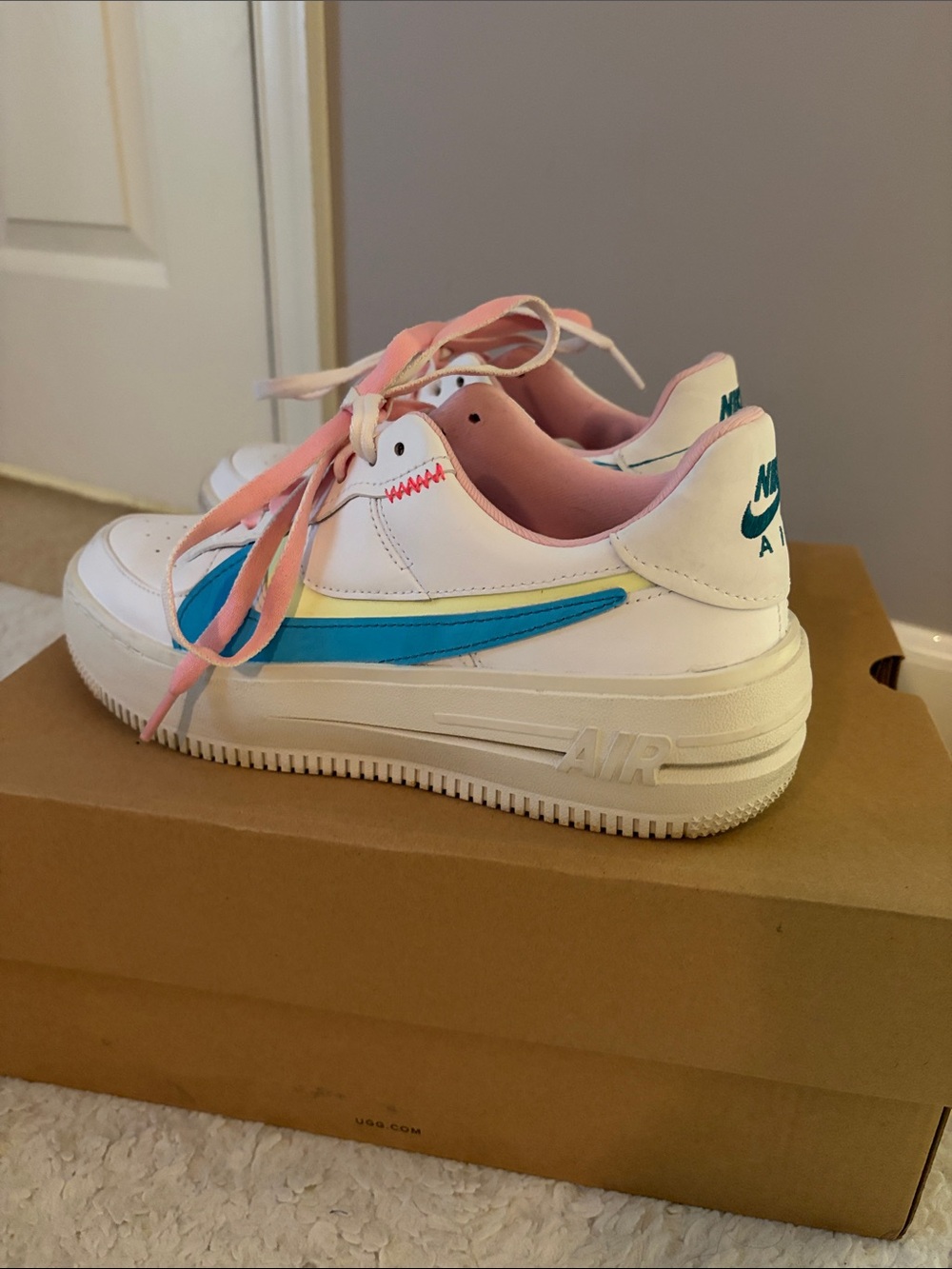 Nike Woman’s White Sneakers with Blue Swoosh and Pink Laces